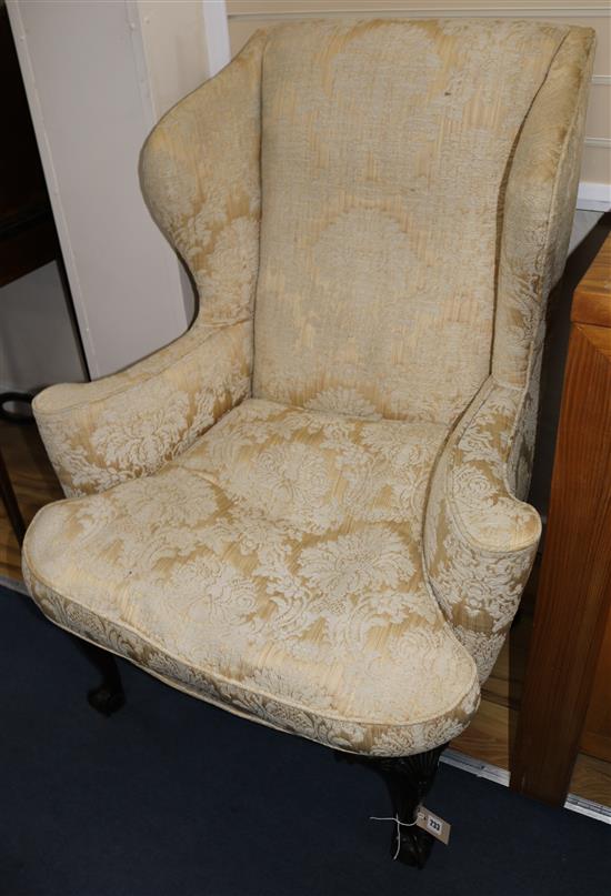 A Queen Anne style carved walnut wing chair